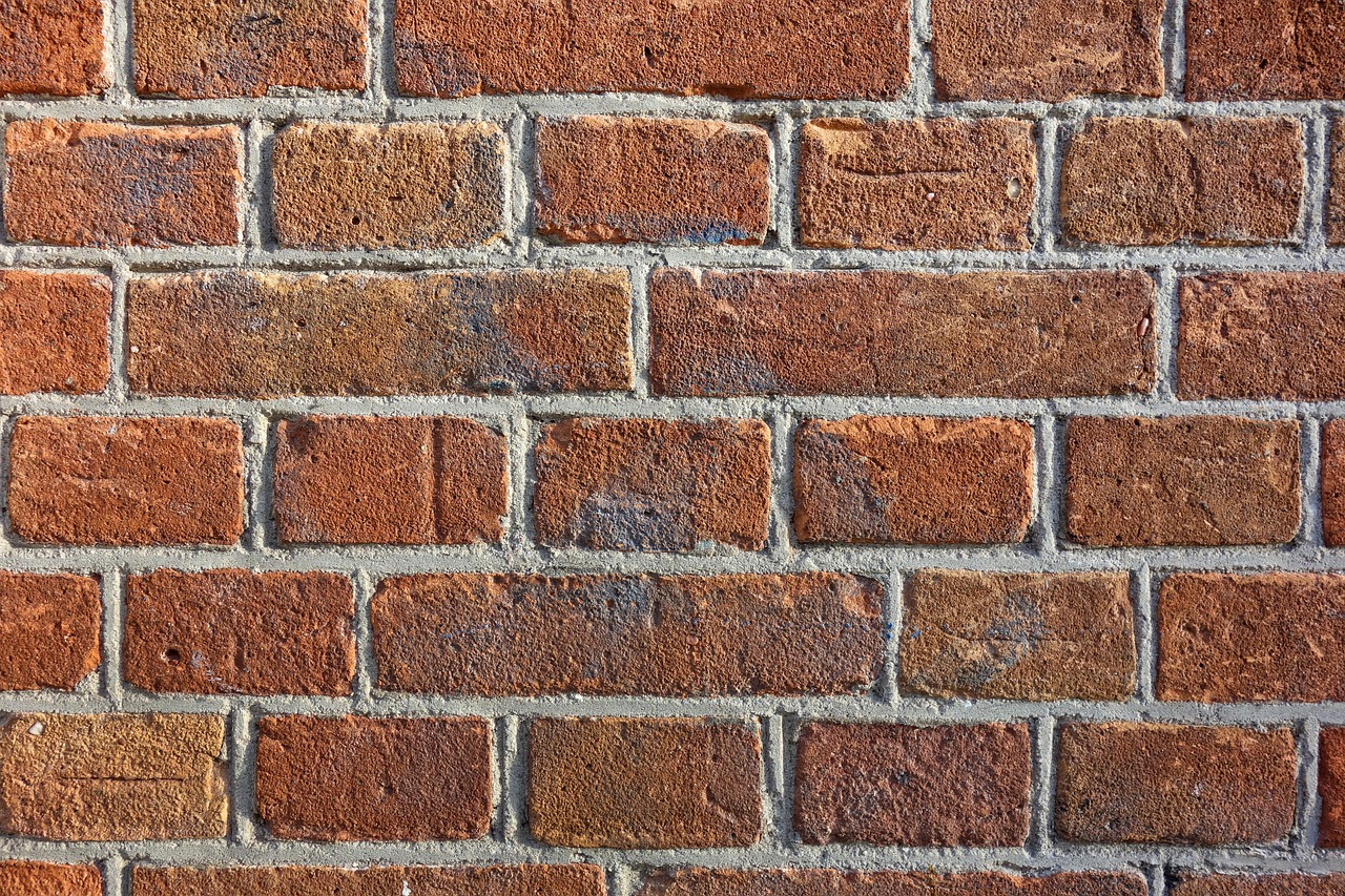 Brick wall with visible cracks requiring professional inspection