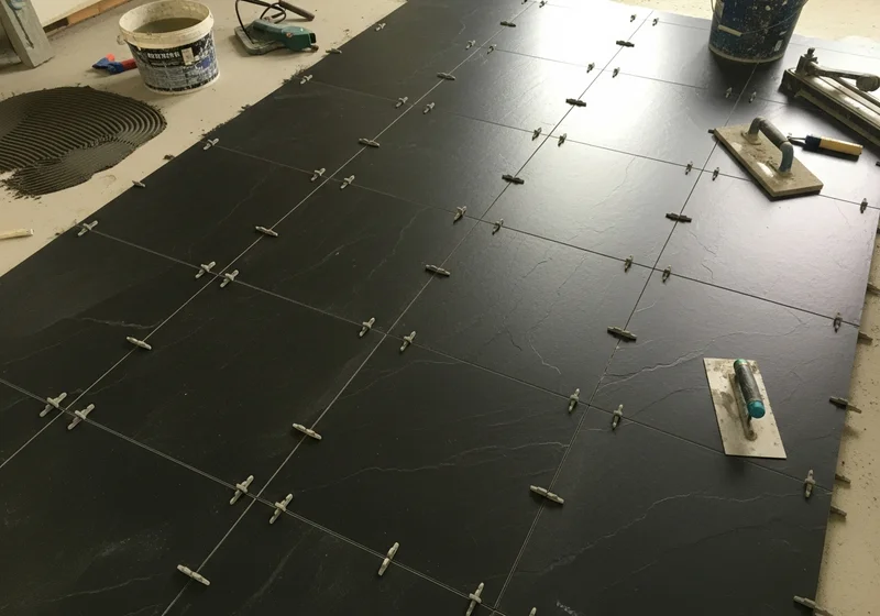 Large format tile being installed in a Grand Rapids kitchen showing the precision work required