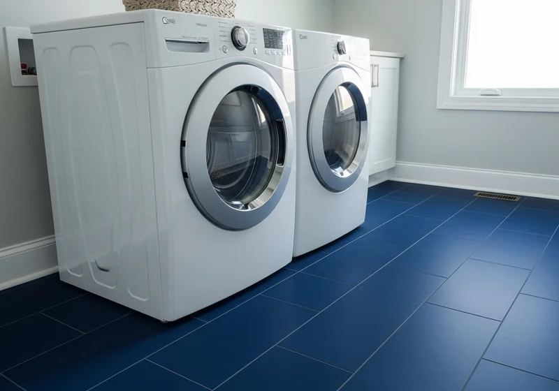 Modern laundry room with deep navy blue porcelain tile floor and white front-load washer and dryer in a West Michigan home