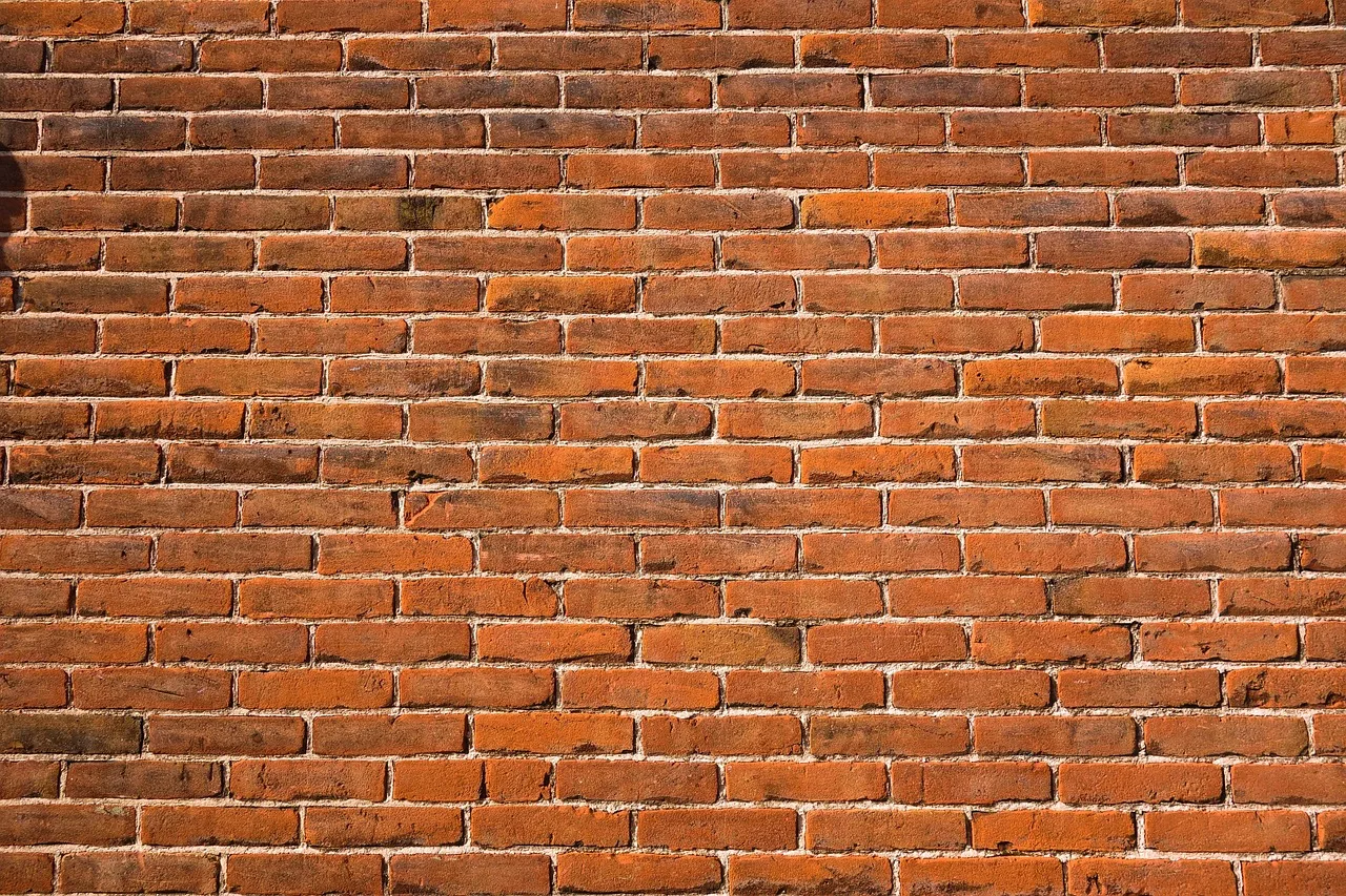 Deteriorating mortar joints in brick wall requiring repointing repair
