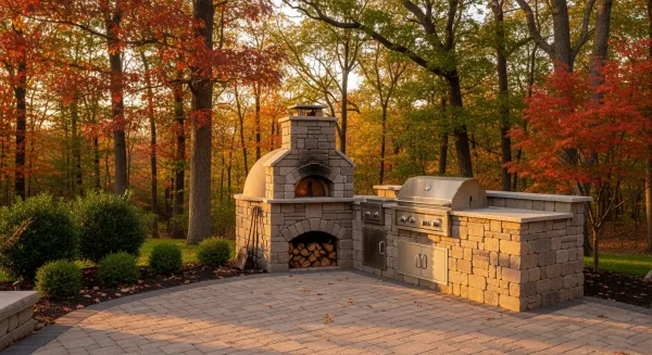 Stone outdoor fireplace and fire pit combination in Michigan residential backyard