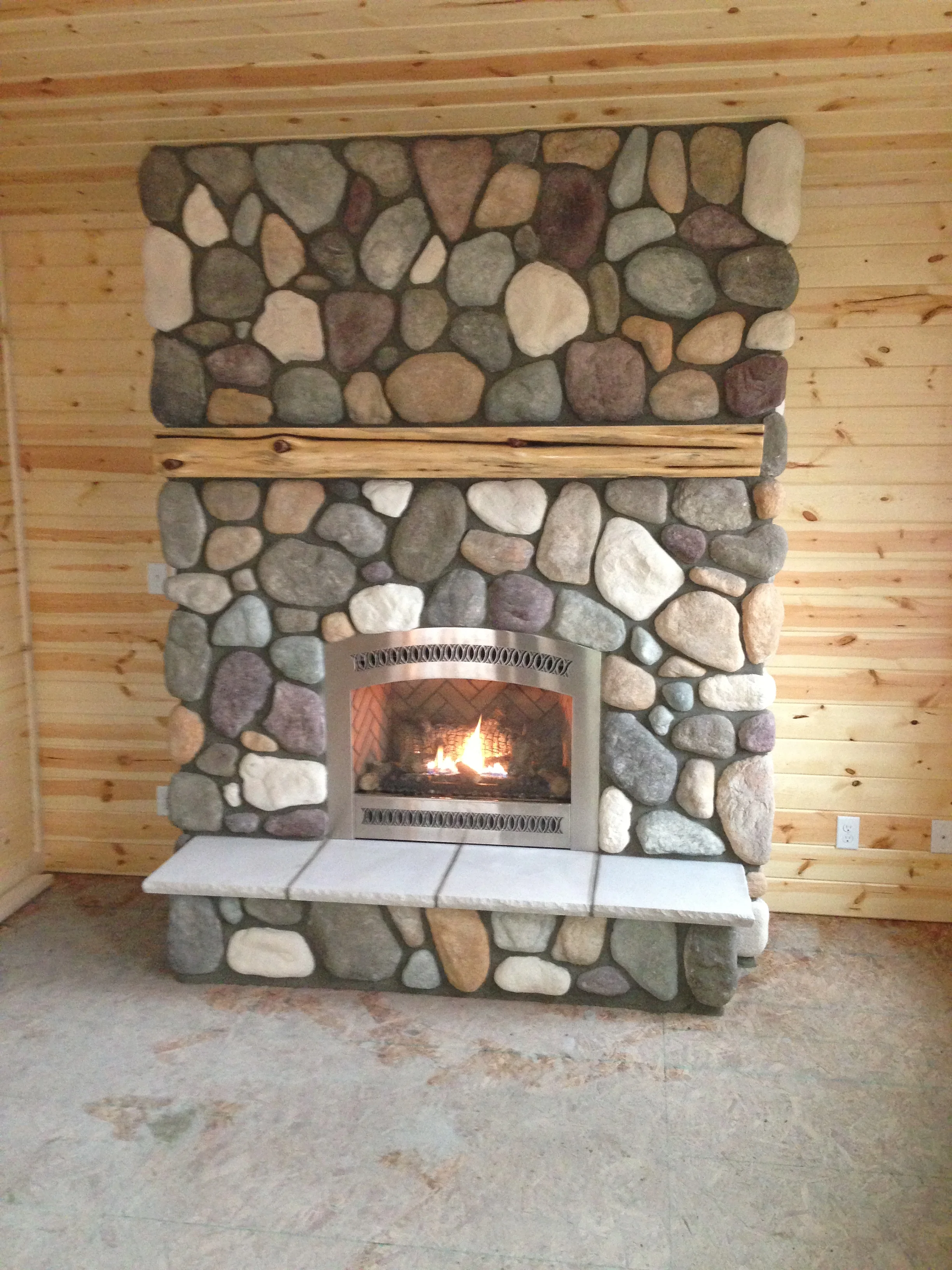 River rock fireplace resurfacing West Michigan - natural stone floor-to-ceiling reface